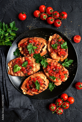Grilled toasts with tomato salsa. Top view with copy space.