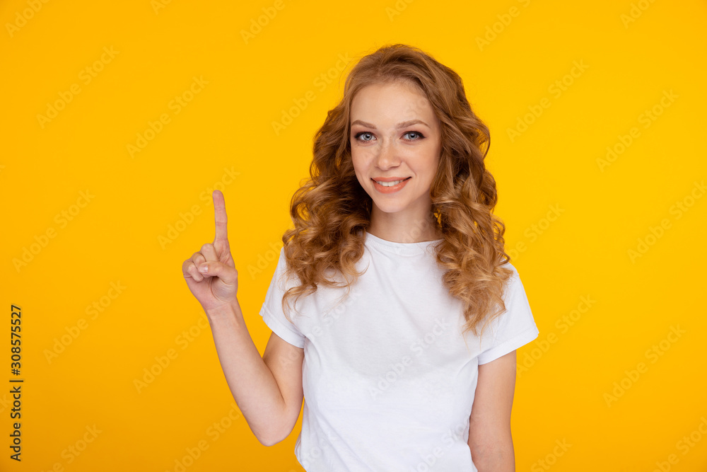 Portrait of handsome woman in the white t-shurt pointing something up Portrait of handsome woman in the white t-shurt pointing something up