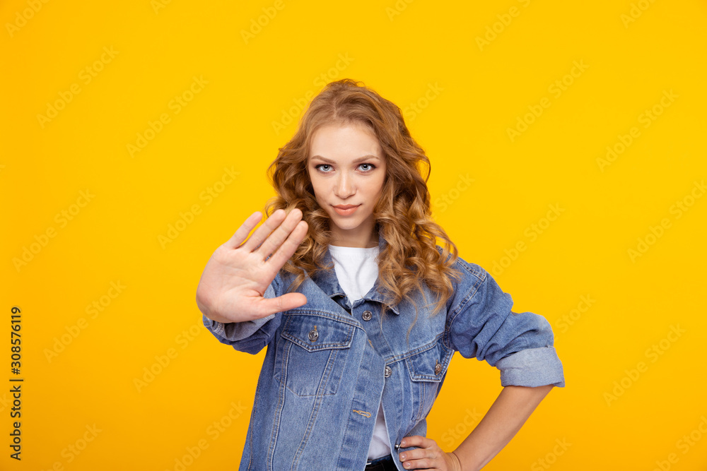 Young lady in denim showing stop getsure Young lady in denim showing stop getsure
