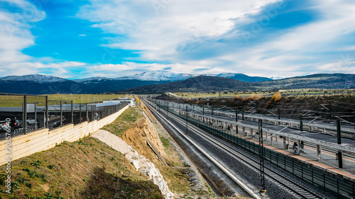 Empty rail station with beautiful snowy mountains in the background