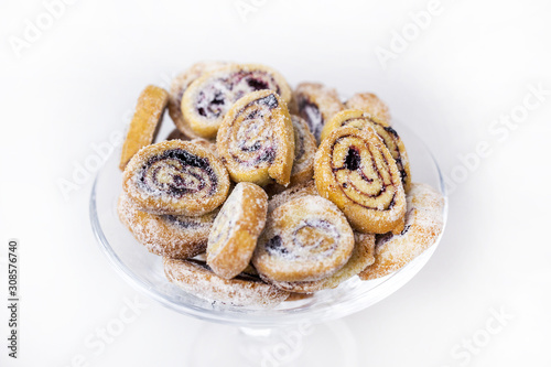 cookies in the form of roll in sweet jam and icing sugar