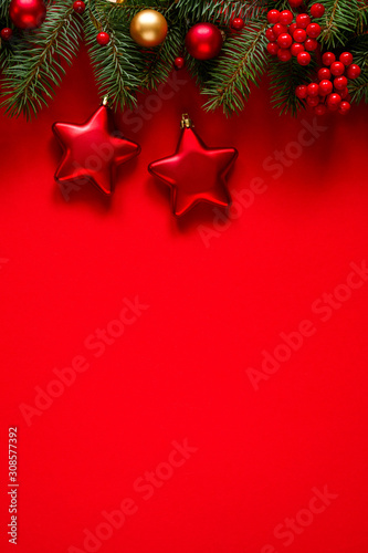Fir branches and holiday decorations on a red background  top view with space for text. Christmas winter background  Christmas card. 
