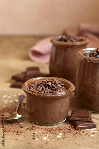 Homemade chocolate pudding in a vintage glass jars.