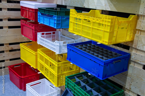 Colored vegetable boxes plastic on stand. Agriculture photo