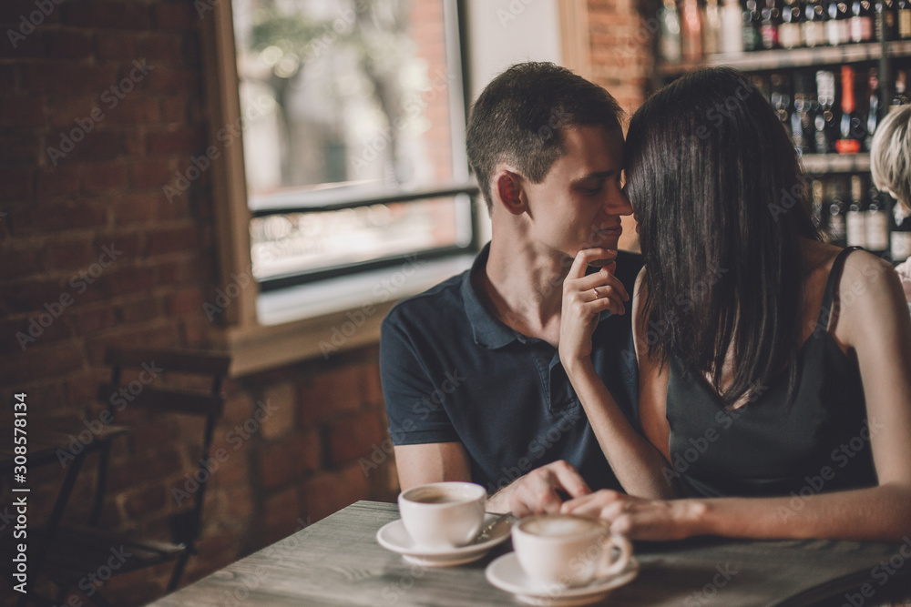 Loving couple hugging in the cafe.