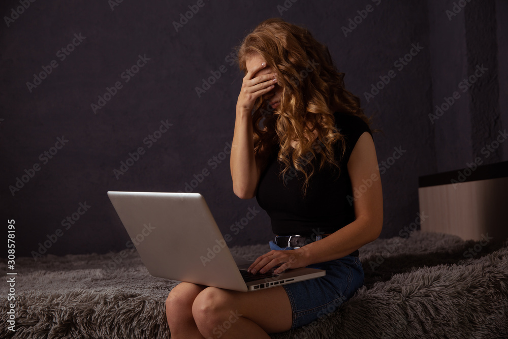 Frustrated woman in tence working on a laptop at home Frustrated woman in tence working on a laptop at home