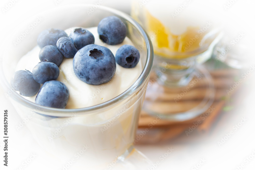 Blueberry greek yogurt in a glass, yogurt parfait with granola, close up Blueberry greek yogurt in a glass, yogurt parfait with granola, close up