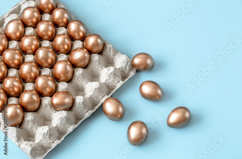 Background with Easter eggs in gold color.