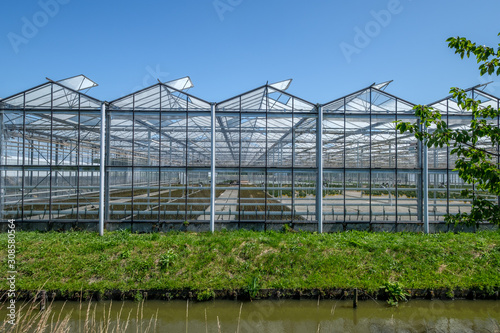 Frontal view of a commercial glass greenhouse in Westland in the Netherlands