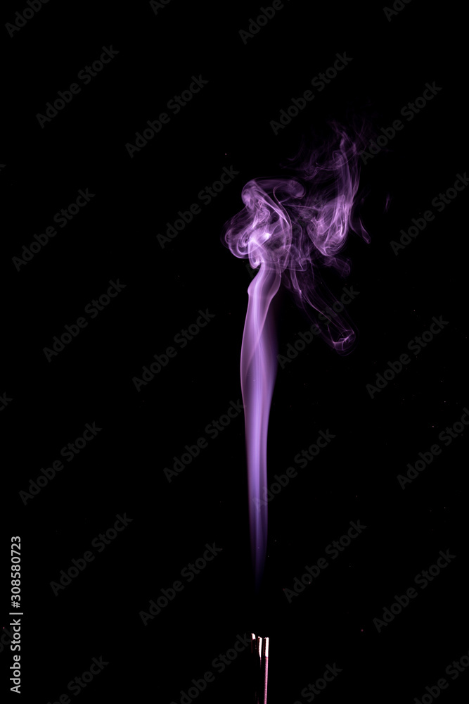 Purple smoke trailing upwards abstract on a black background