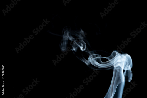 White whispy and wavy smoke abstract on a black background