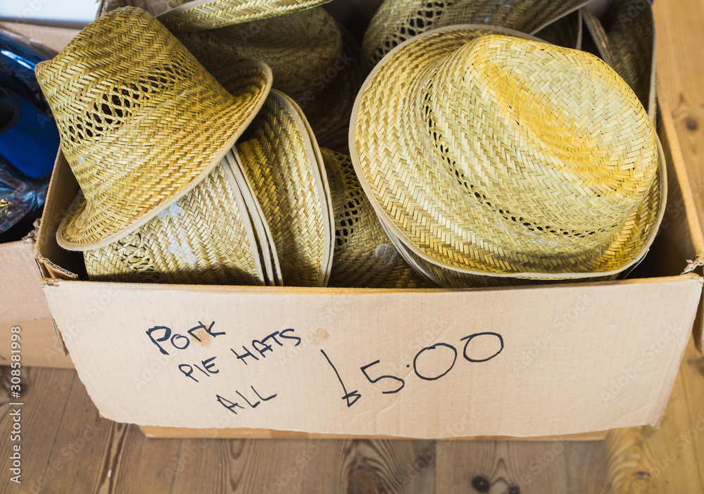 Pork Pie hats all £5 pounds for sale in a cardboard box sold to tourists