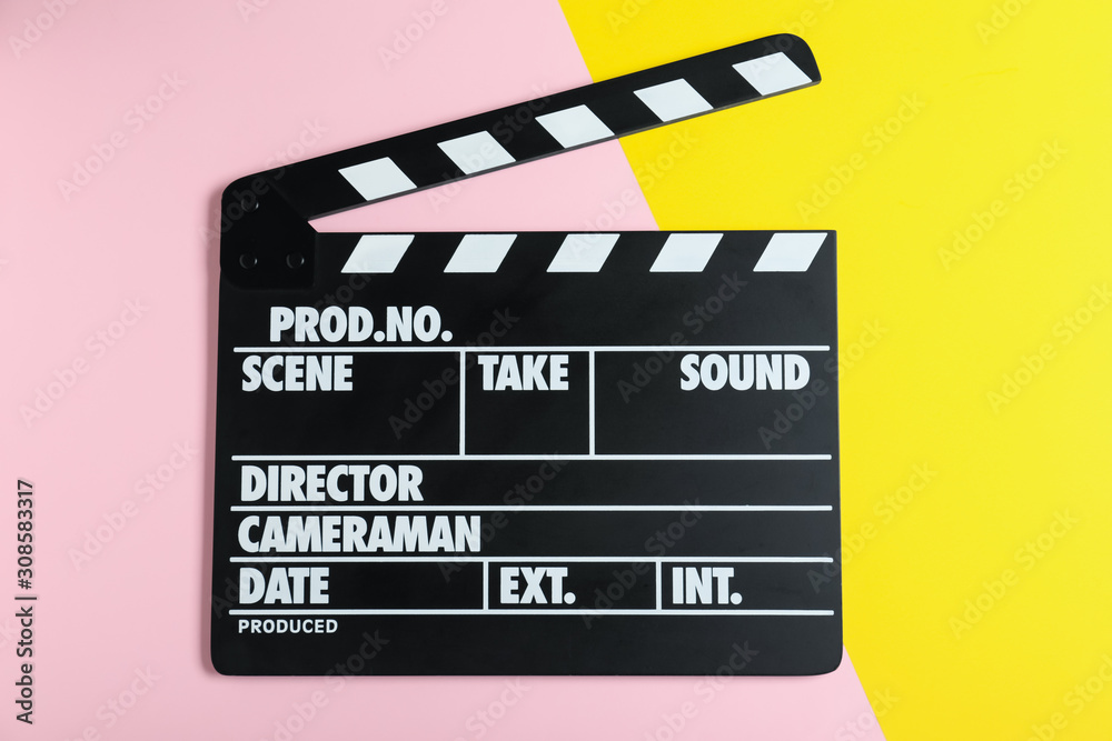 Clapper board on color background, top view. Cinema production