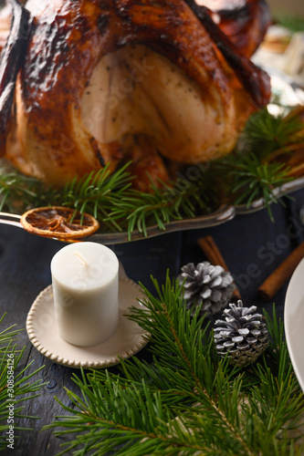 Fototapeta Naklejka Na Ścianę i Meble -  Thanksgiving and holiday. Braised turkey on the served table. Vertical frame.