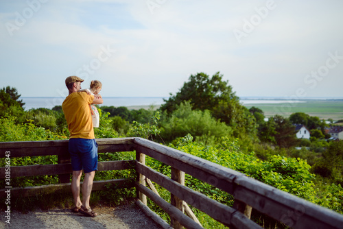 Happy loving family. Father and his daughter child girl playing and hugging outdoors. Cute little girl hugs daddy. Concept of Father's day