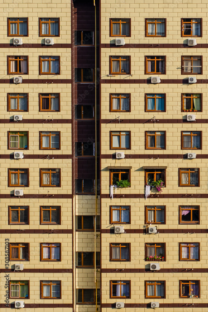 Geometric facade of a yellow residential building