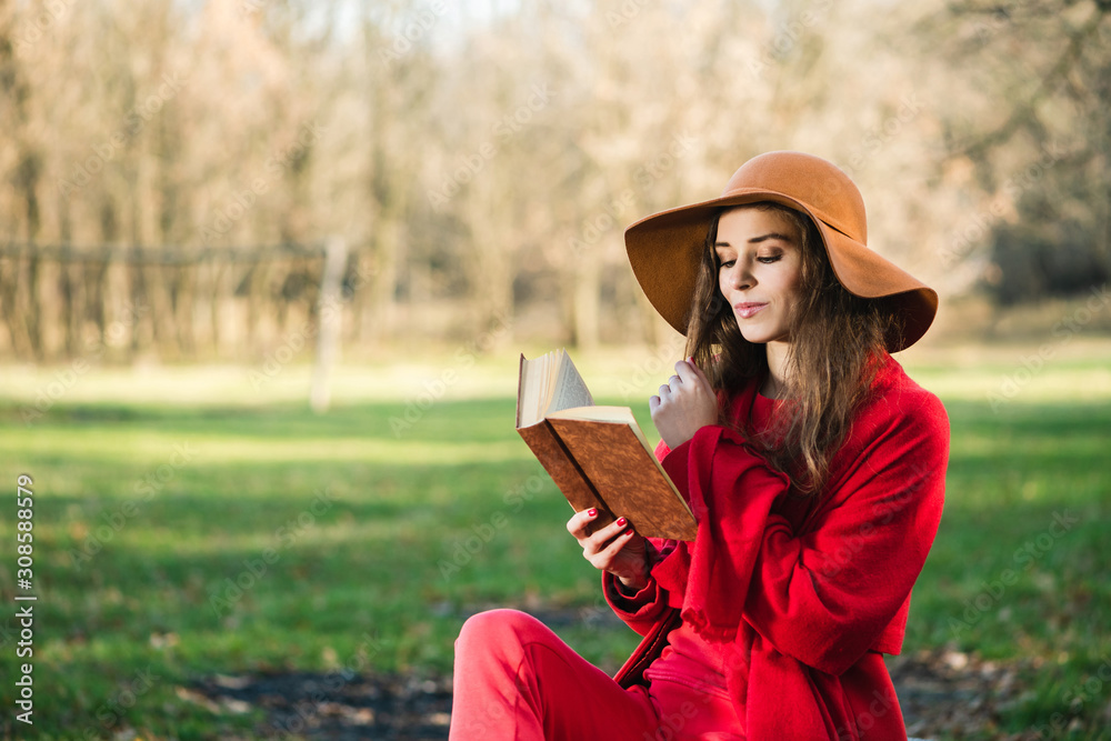 Portrait of beautiful brunette girl with book