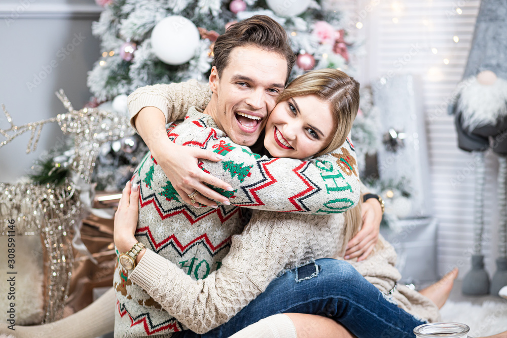 A guy with a girl is celebrating Christmas. A loving couple enjoy each other on New Year's Eve. New Year's love story A guy with a girl is celebrating Christmas. A loving couple enjoy each other on New Year's Eve. New Year's love story