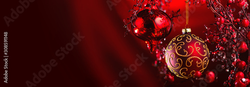 Christmas and New Year Red Decoration. Abstract Blurred Bokeh Holiday Background with beautiful baubles and Blinking Garland. Christmas Tree Lights Twinkling. Xmas backdrop art design