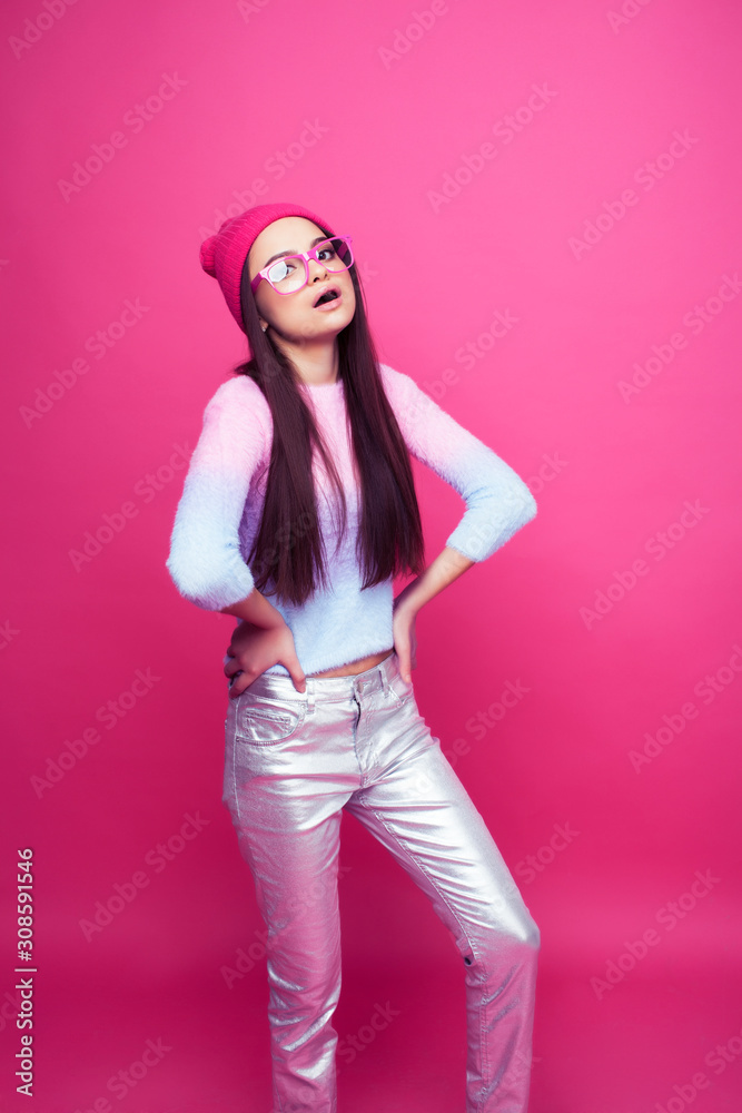 young pretty brunette girl posing on pink backgroundwearing glasses and hat, lifestyle people happy smiling concept young pretty brunette girl posing on pink backgroundwearing glasses and hat, lifestyle people happy smiling concept