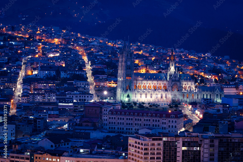 Quito at night, panoramic view of the old city and the National Basilica in blue tones