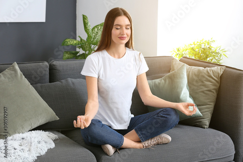 Beautiful woman meditating ...