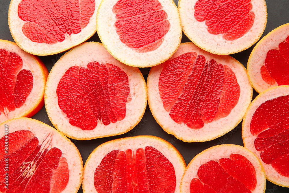 Fresh cut grapefruit on dark background Fresh cut grapefruit on dark background