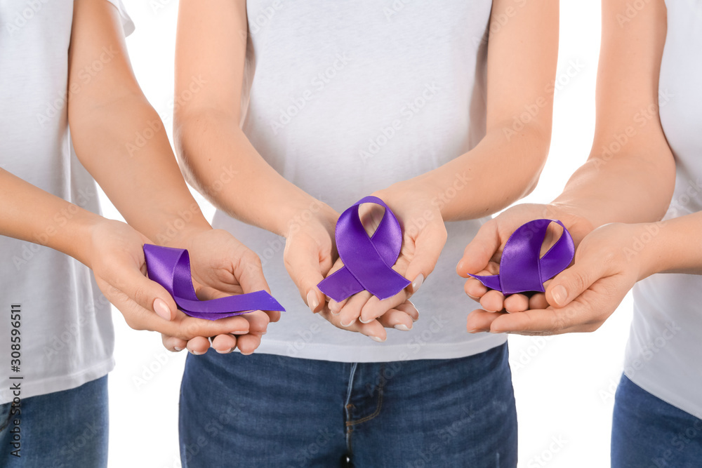 Obraz premium Women with purple ribbons as symbol of World Cancer Day on white background