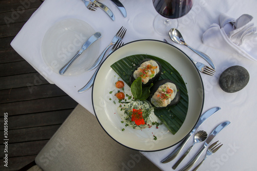 Stir fried potatoes in seaweed crust stuffed with tuna tartar. Exquisite dish. Creative restaurant meal concept. photo