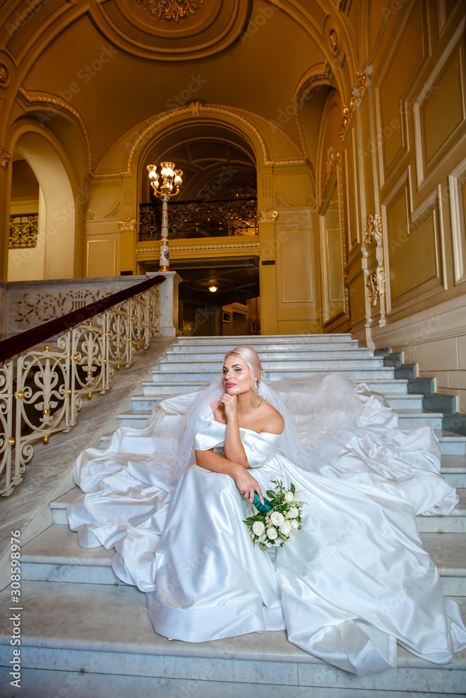 bride is sitting on the stairs