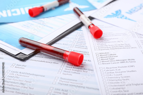 Laboratory test form and blood samples on table