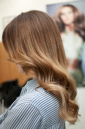 hairstyle of long wavy hair on a woman in profile