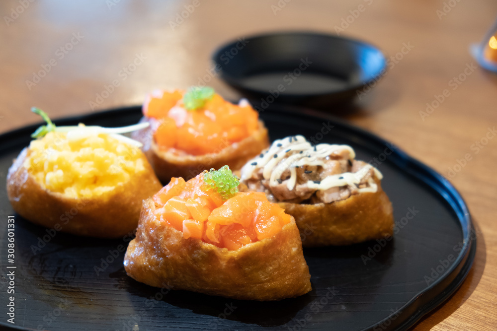 A plate of sushi with beancurd skin A plate of sushi with beancurd skin