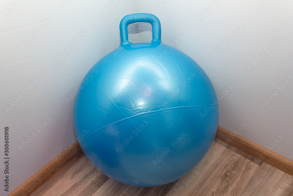 Blue inflatable fitness ball on the floor Blue inflatable fitness ball on the floor