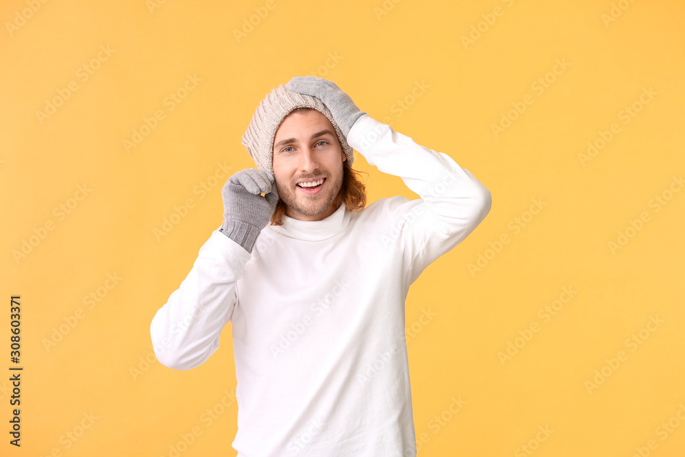 Handsome man in winter clothes on color background Handsome man in winter clothes on color background