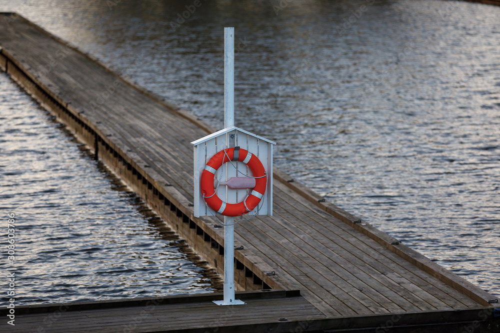 equipment for safety on the water. the harbour with a wooden pier with a rope and lifeline equipment for safety on the water. the harbour with a wooden pier with a rope and lifeline
