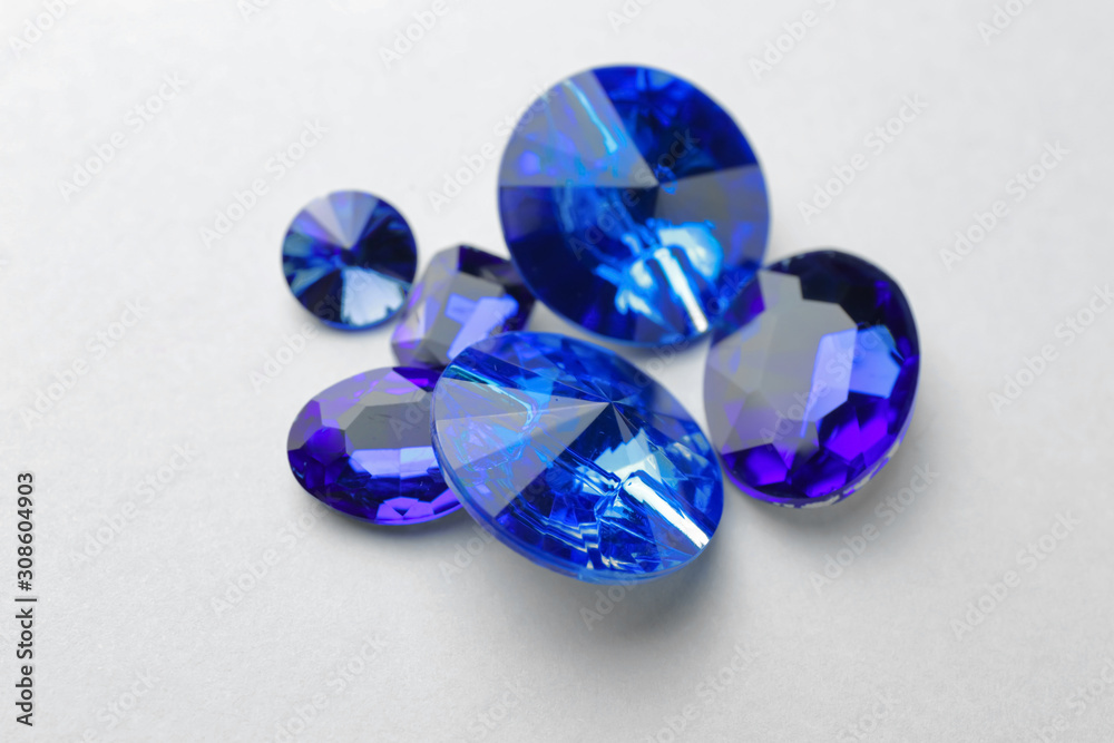 Precious stones for jewellery on light background Precious stones for jewellery on light background