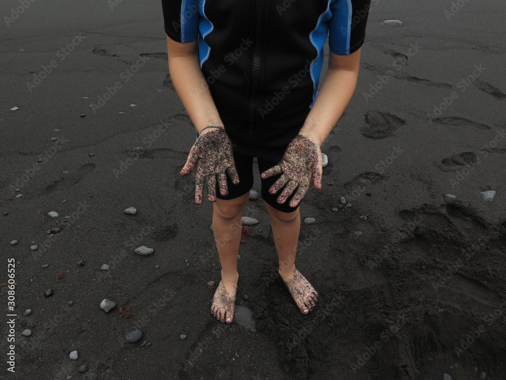 girl with neoprene and sand in her hands