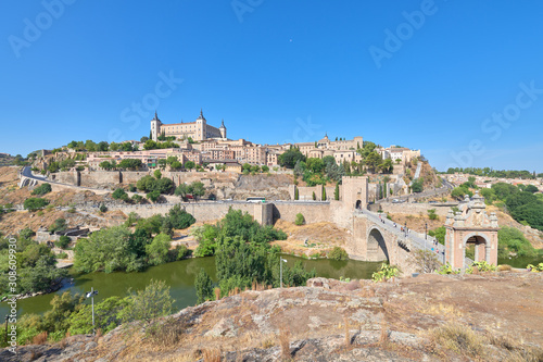 Landscape view of the old town of the medieval city of Toledo from above the Alcantara bridge over the Tagus river, Castilla la Mancha, Spain