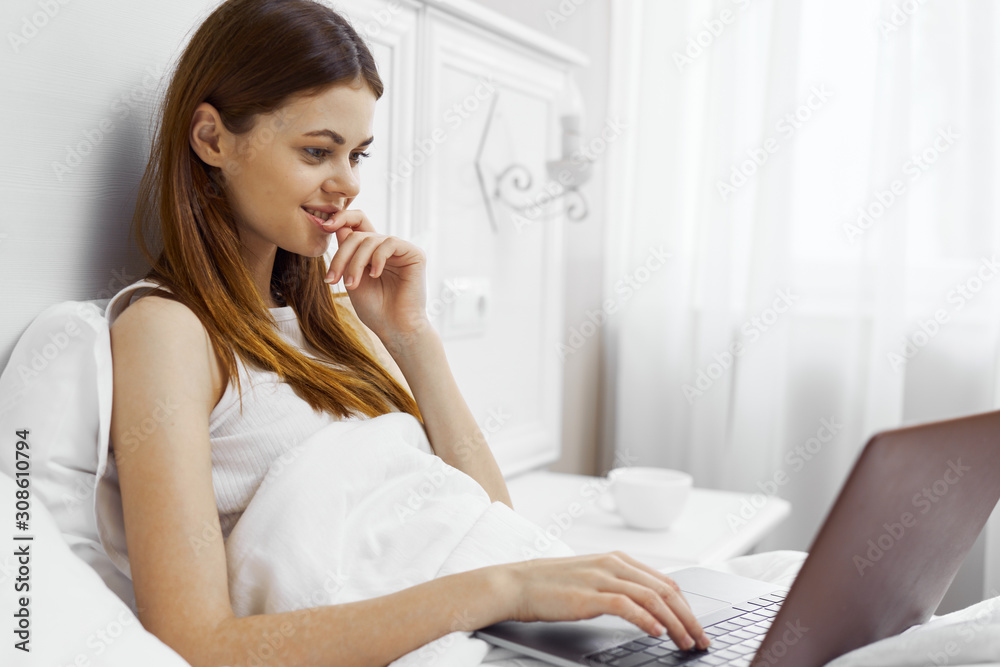 woman sitting on sofa and using mobile phone woman sitting on sofa and using mobile phone