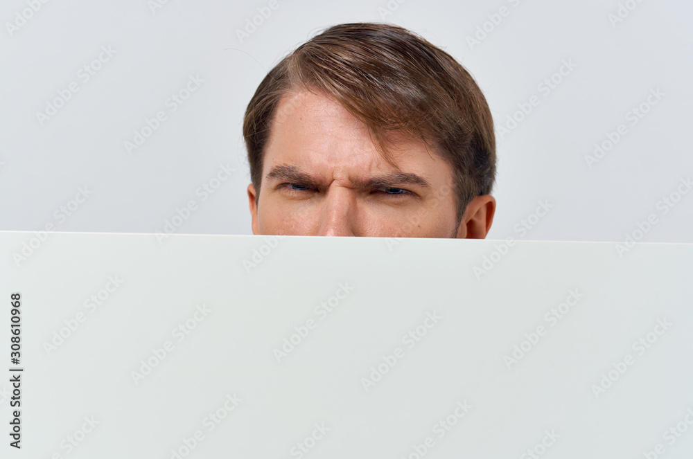 portrait of young man holding blank billboard portrait of young man holding blank billboard