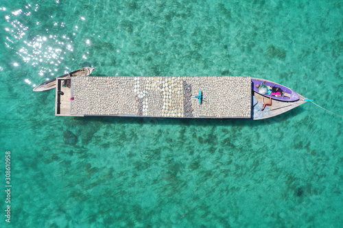 Aerial view dried salted fish at the top of the sea gypsy traditional boat house.