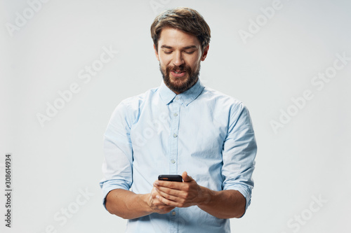 young man texting on his phone © SHOTPRIME STUDIO