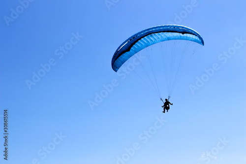 Paragliding in the blue sky on a sunny day.