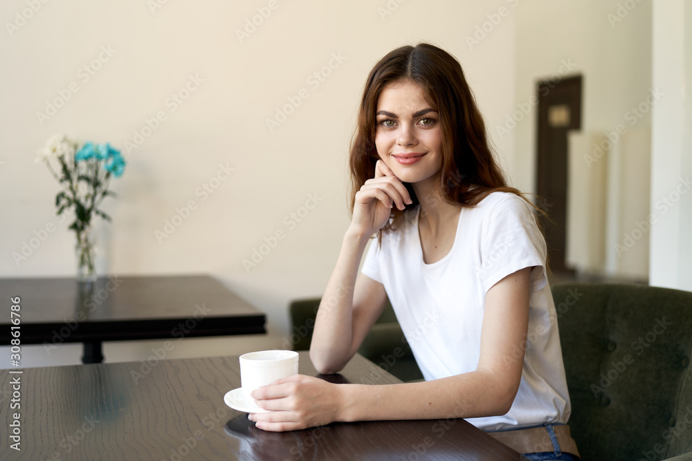 young woman sitting on sofa and talking on cell phone young woman sitting on sofa and talking on cell phone