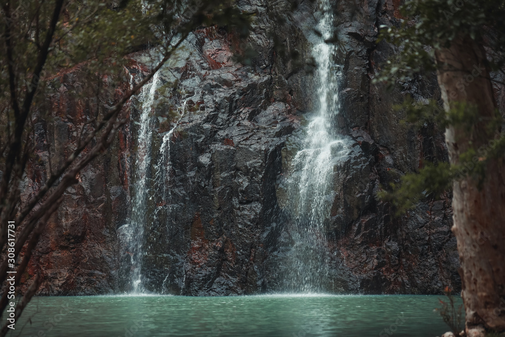 Fototapeta premium Waterfall scene with crisp blue water, Cedar Creek Falls, Queensland Australia