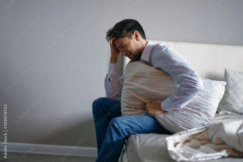 man sitting on sofa at home man sitting on sofa at home