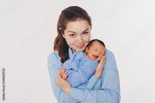 the concept of a healthy lifestyle, the protection of children, shopping - baby in the arms of the mother. Woman holding a child. Isolated on white background. Copy space