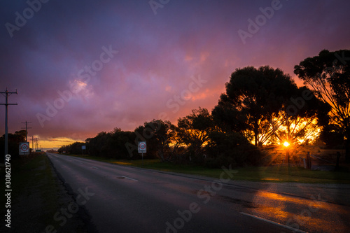 Vibrant pink and purple sunset sky on a country road in Central Victoria, Australia