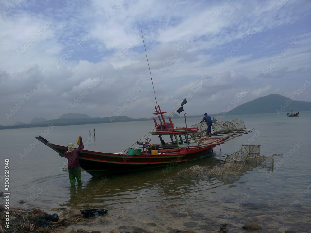 fisherman prepare their boat for fishing near the beach